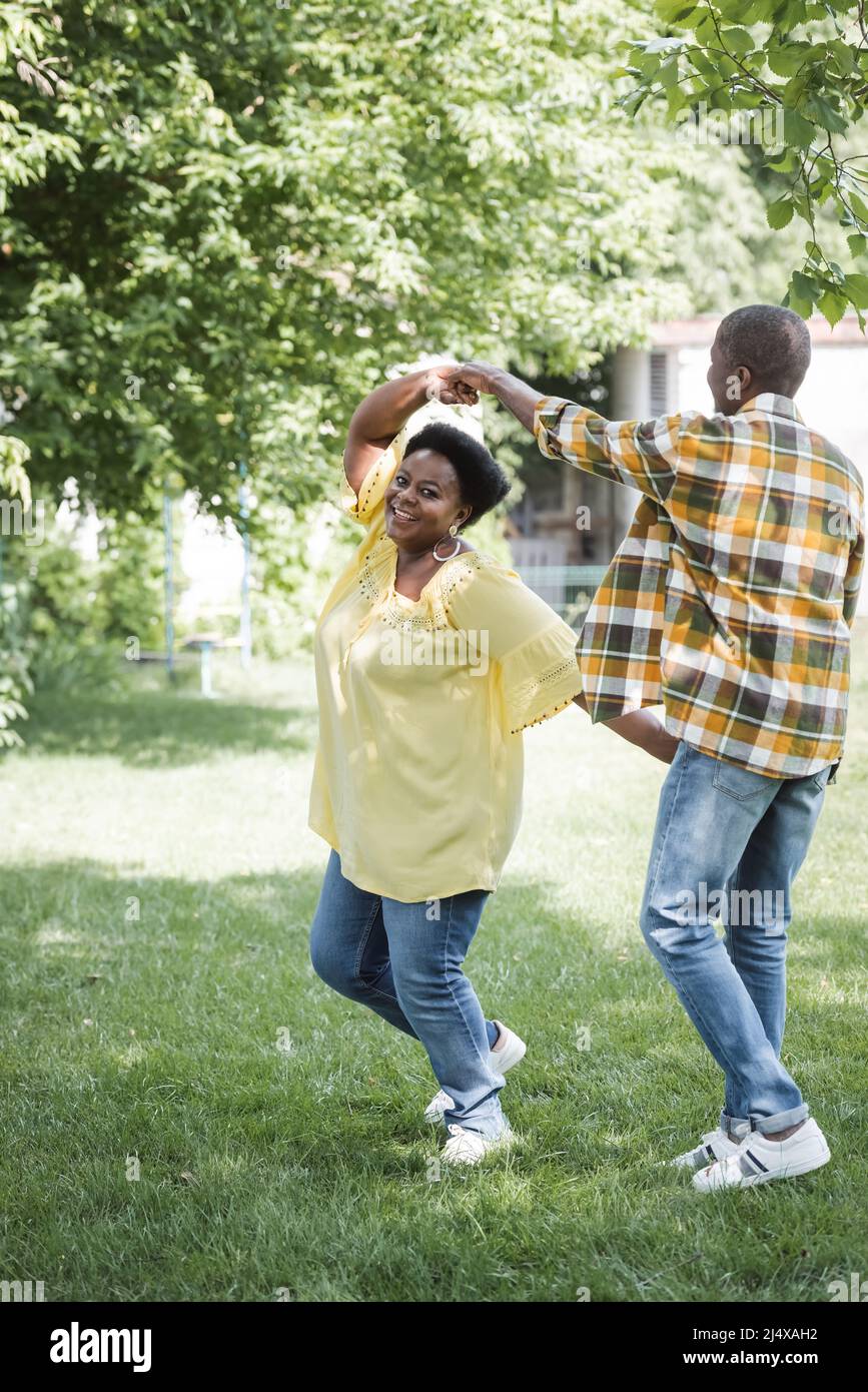 full length of happy senior african american couple dancing in park ...