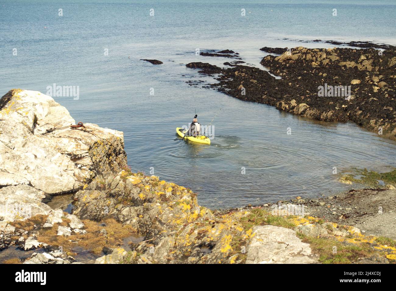 Sea kayaker sets out to do some fishing from the tiny cove at Porth