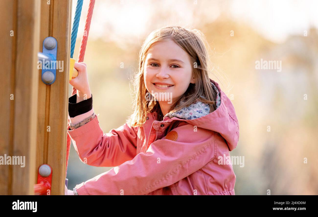 Beautiful little girl playing at the playground Stock Photo - Alamy