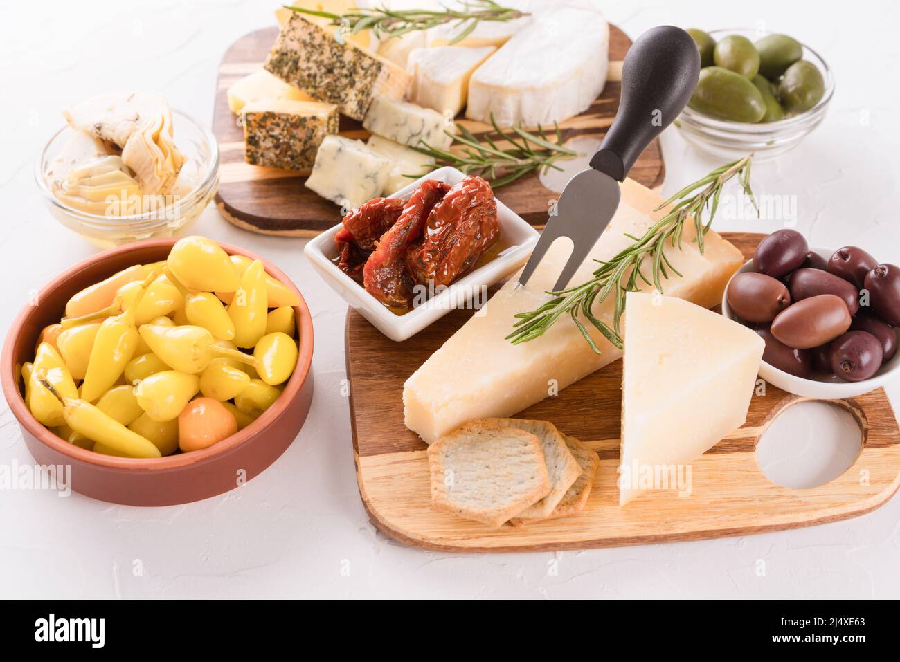Solid and softripened cheeses served with olives, pickled baby peppers