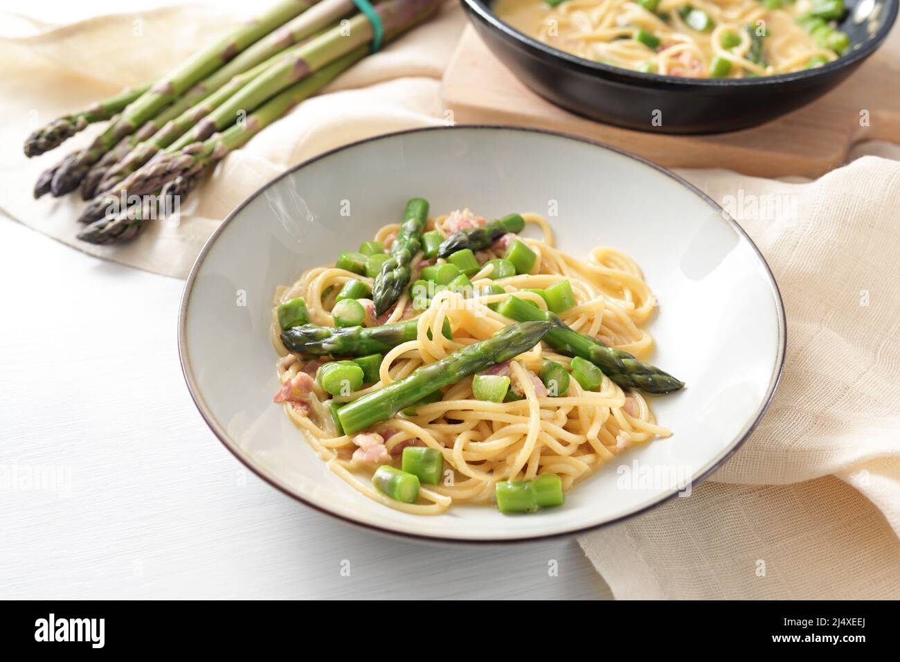 Spaghetti carbonara variation with green asparagus served in a plate ...