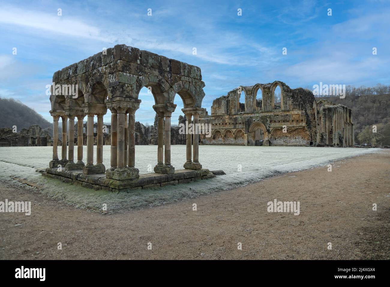 Recreated arcade (foreground) in the cloister with 'laver' (washing) facility behind in the arcade wall  of ruined Rievaulx Cistercian Abbey Stock Photo