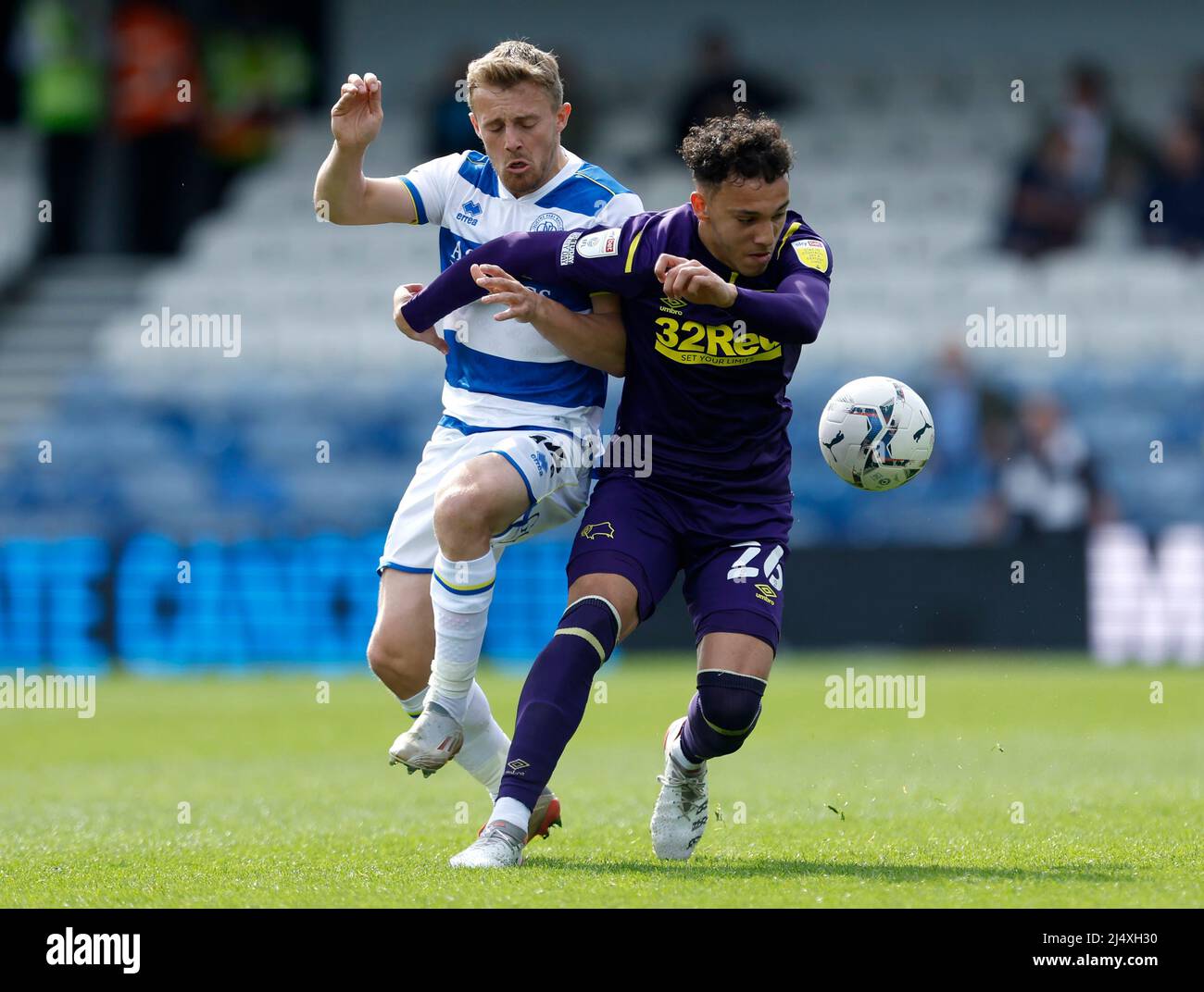Queens Park Rangers' George Thomas (left) and Derby County's Lee Buchanan battle for the ball during the Sky Bet Championship match at the Kiyan Prince Foundation Stadium, London. Picture date: Monday April 18, 2022. Stock Photo