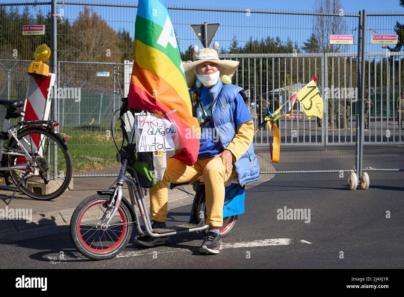 18 April 2022, Rhineland-Palatinate, Büchel: A participant of the Easter march stands with a scooter in front of the main gate of the Bundeswehr air base. American nuclear weapons are to be stored at the base. Photo: Thomas Frey/dpa Stock Photo