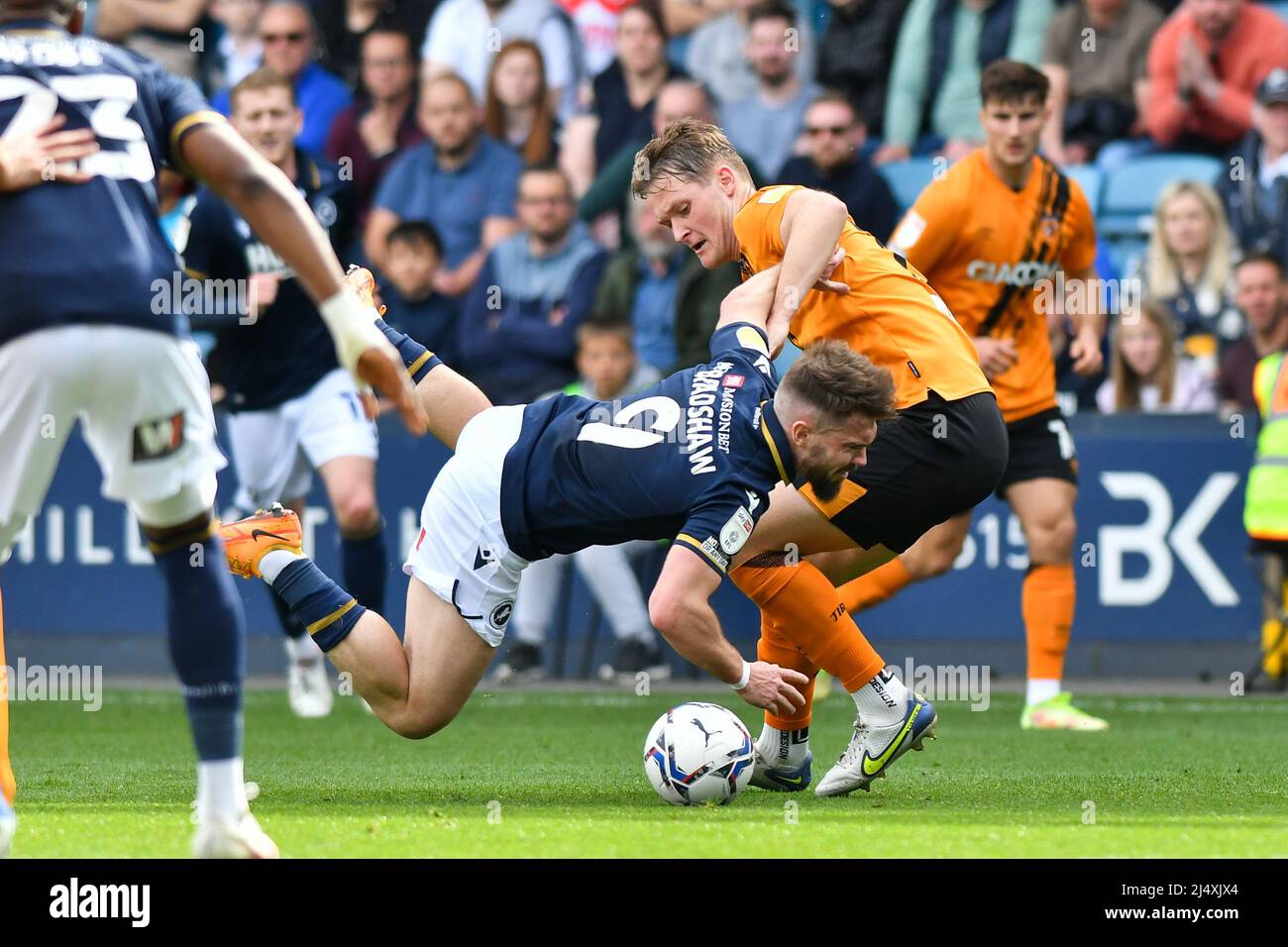 LONDON, UK. APR 18TH Tom Bradshaw of Millwall battles for possession with Sean McLoughlin of Hull City during the Sky Bet Championship match between Millwall and Hull City at The Den, London on Monday 18th April 2022. (Credit: Ivan Yordanov | MI News) Credit: MI News & Sport /Alamy Live News Stock Photo