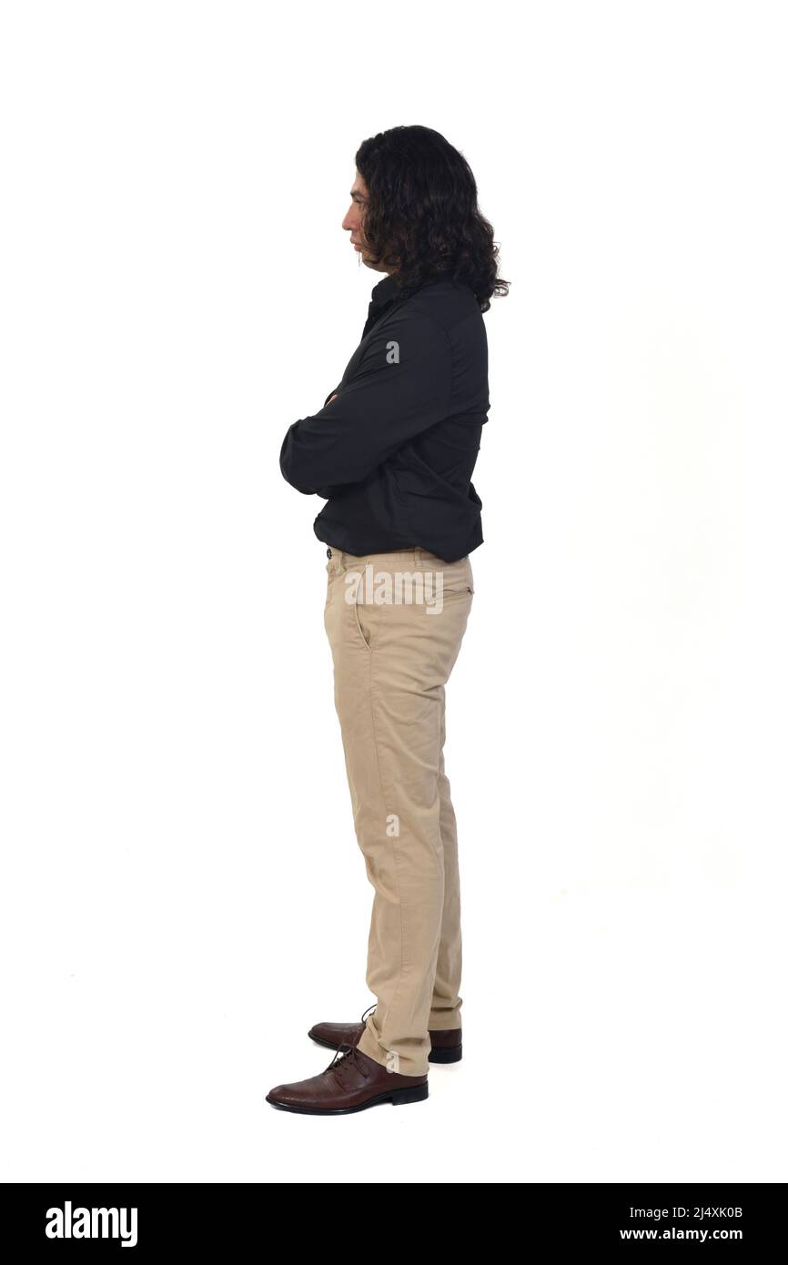 side view of a man with shirt and long hair arms crossed on white ...