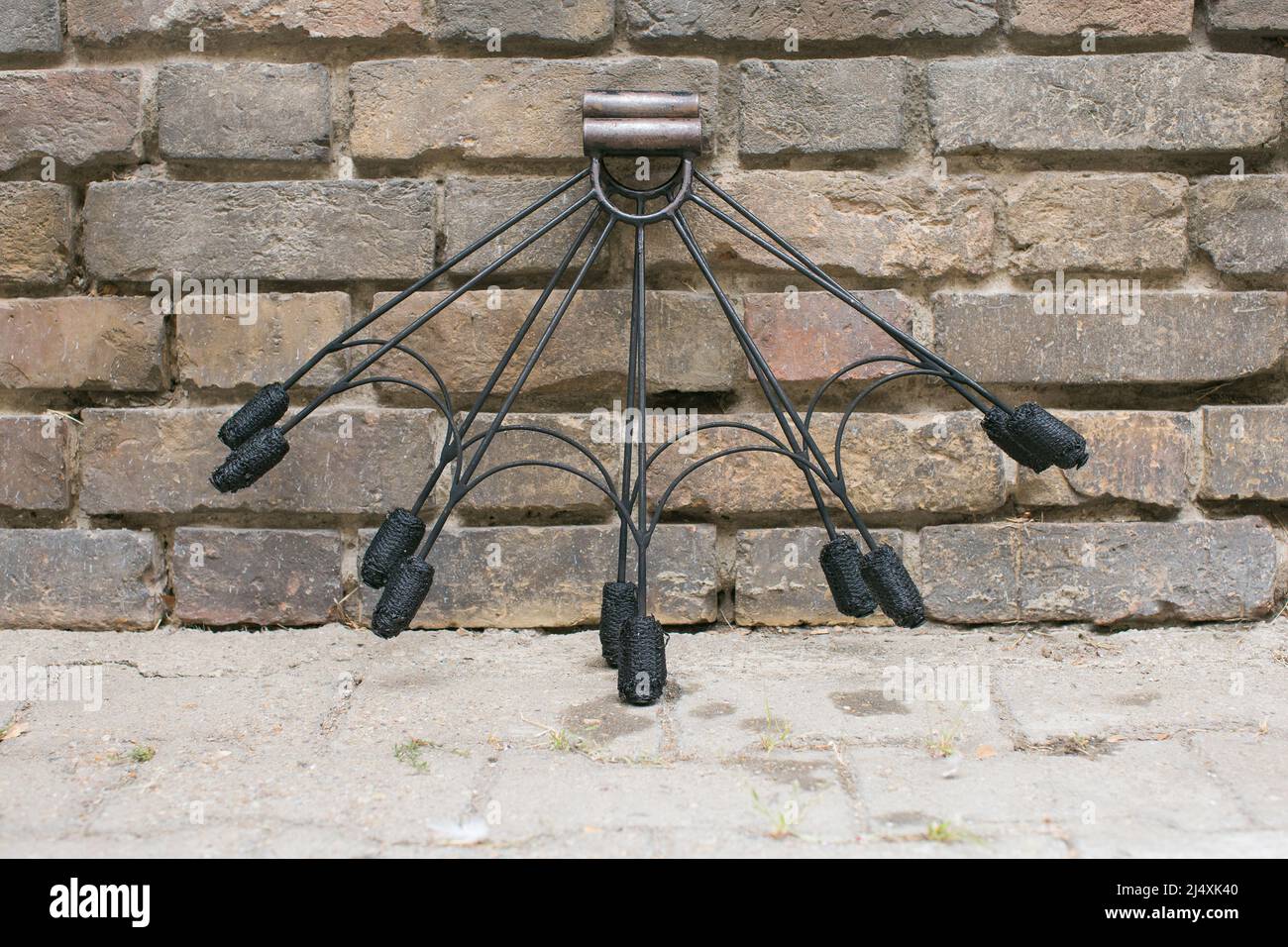 fire dancing equipment resting on a brick wall Stock Photo Alamy