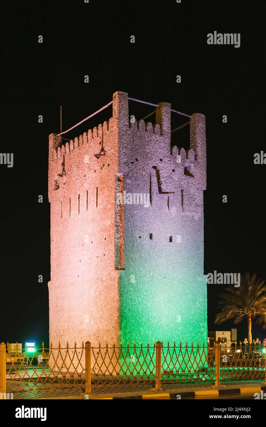 Night View Of Ancient Old Stone AlMurabbaa Watchtower Of Ajman. Close Up Details. Famous Landmark Stock Photo