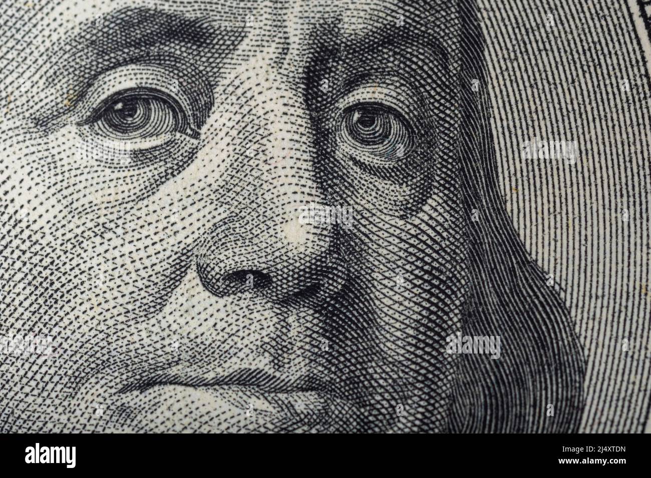 Portrait of Ben Franklin on the US $100 dollar bill in macro. Benjamin Franklin on hundred dollar American banknote. Stock Photo