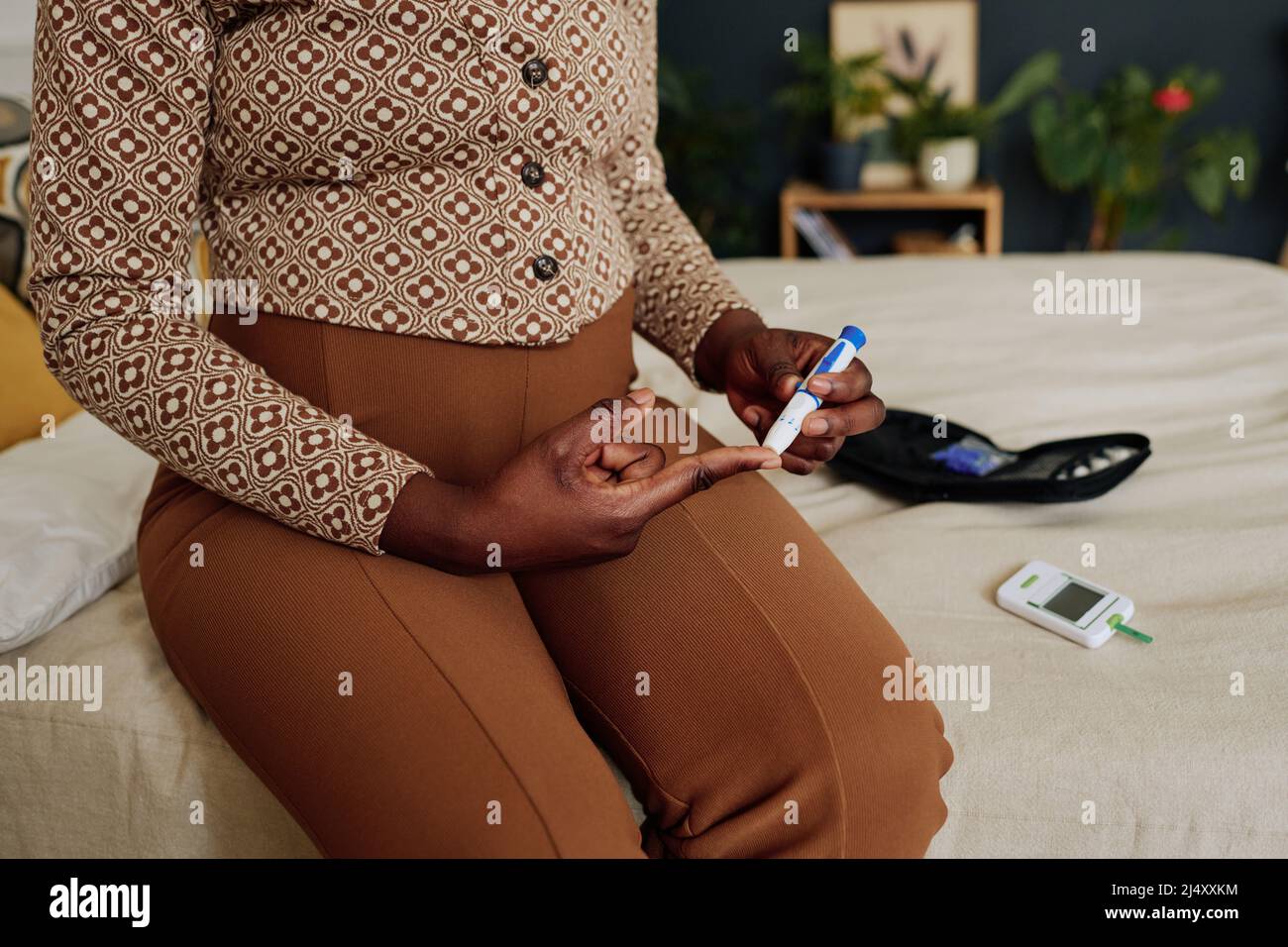 Woman Using Glucometer Close-up of pregnant woman using glucometer to control her blood sugar ...