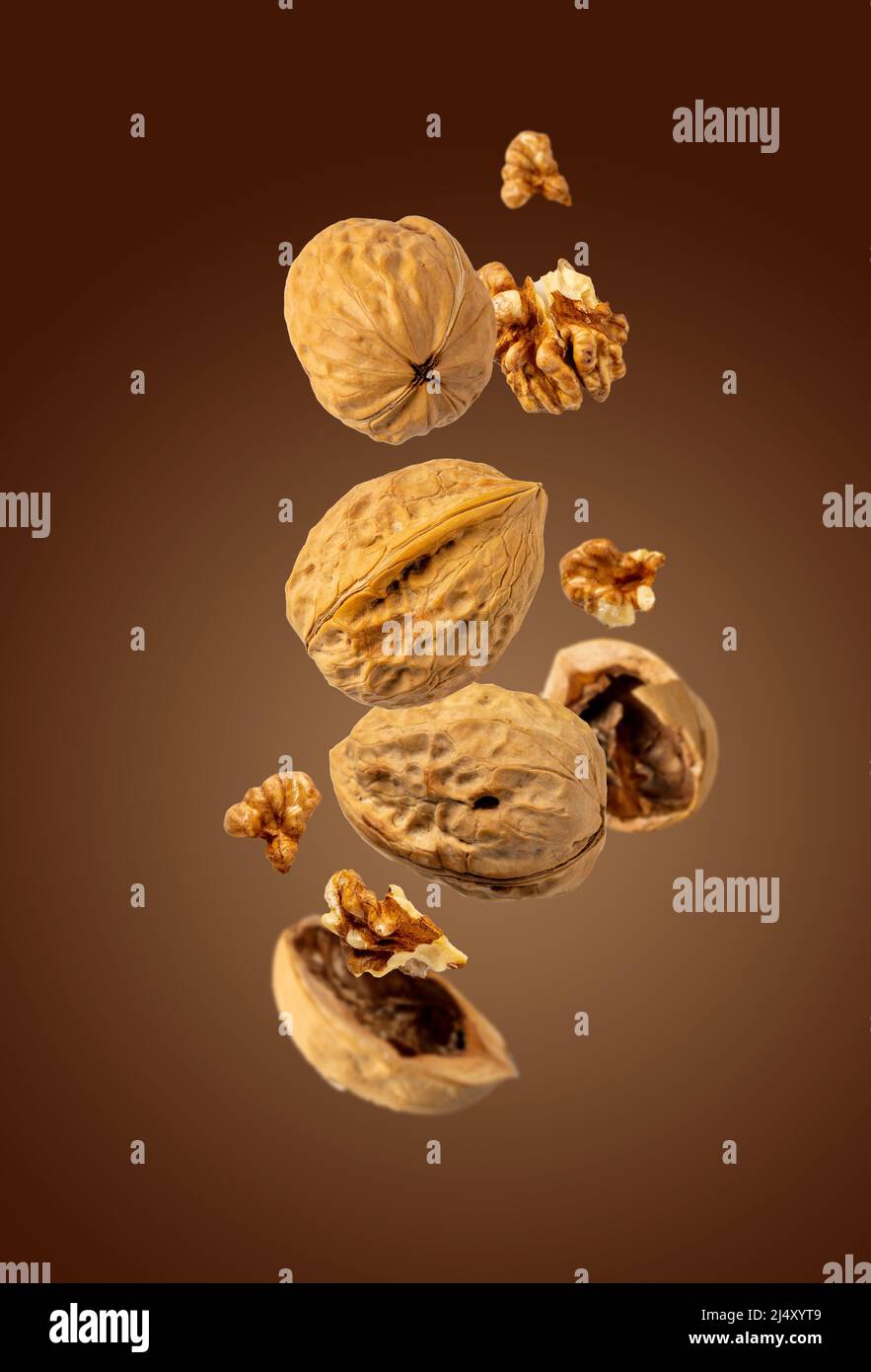 walnuts fly on brown background, selective focus Stock Photo