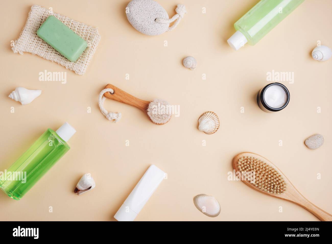 Cosmetic flat lay on neutral beige background. Shower gel, bath foam, body brush, face cream, natural soap, pumice stone and body lotion. Spa and Stock Photo