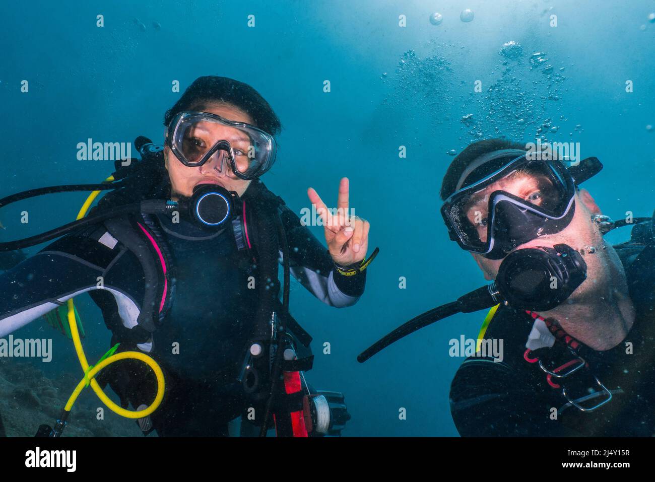 couple performing safety stop while on a dive in the Maldives Stock