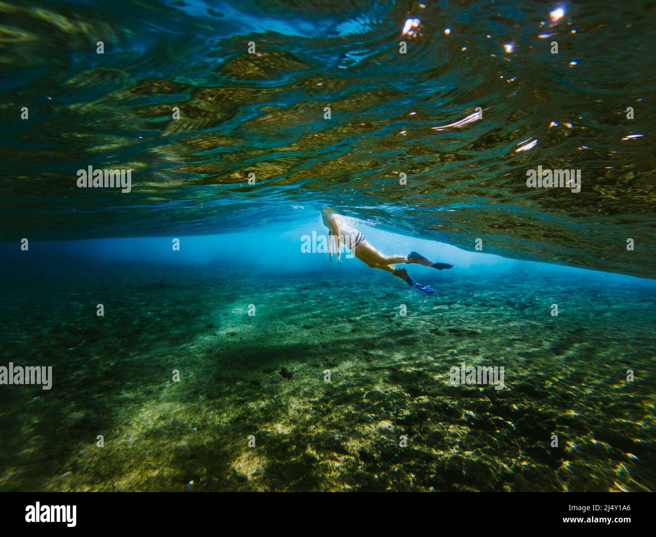 Women snorkels in blue green clear ocean waters Stock Photo Alamy