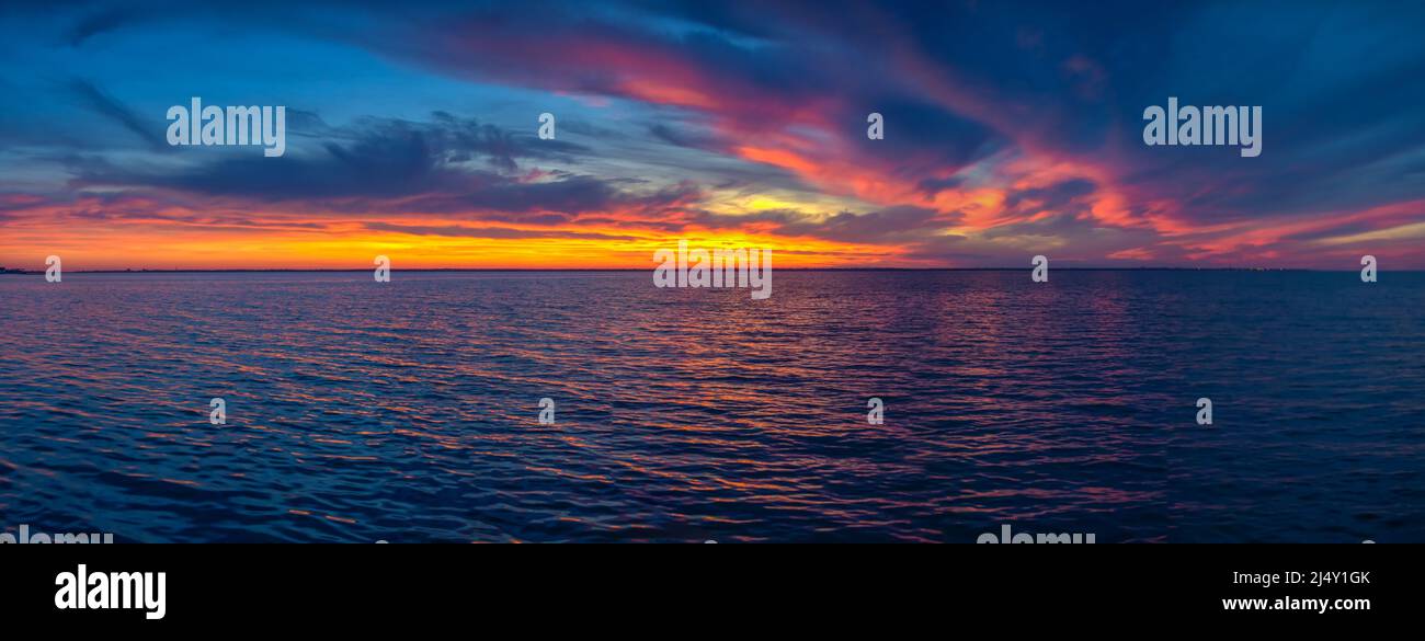 Beautiful sunset over the water surface Stock Photo