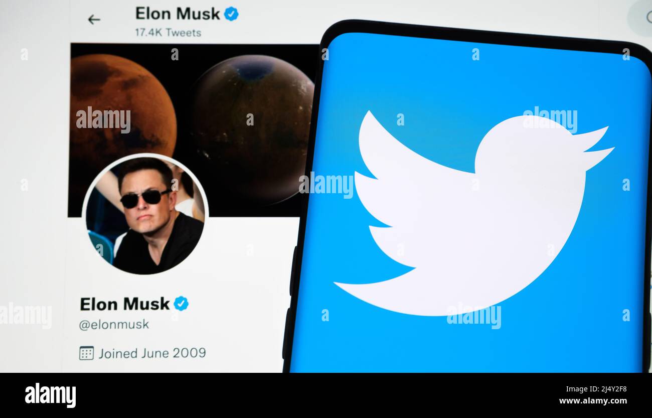 Smartphone with Twitter logo placed on top of public Elon Musk's Twitter account page. Concept for company sale to Elon Musk. Stafford, UK. Stock Photo