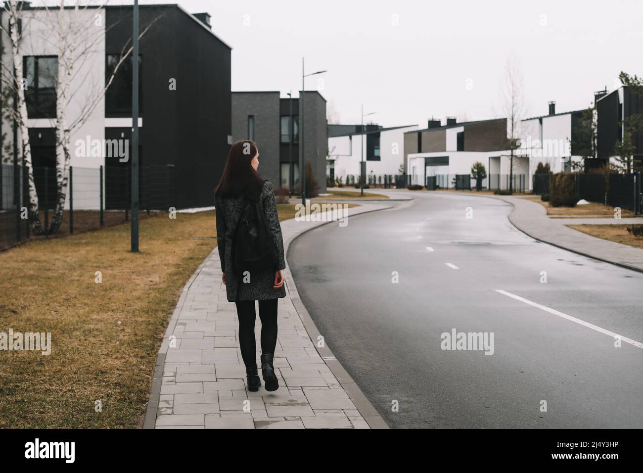young woman walks through the street in spring. Stock Photo