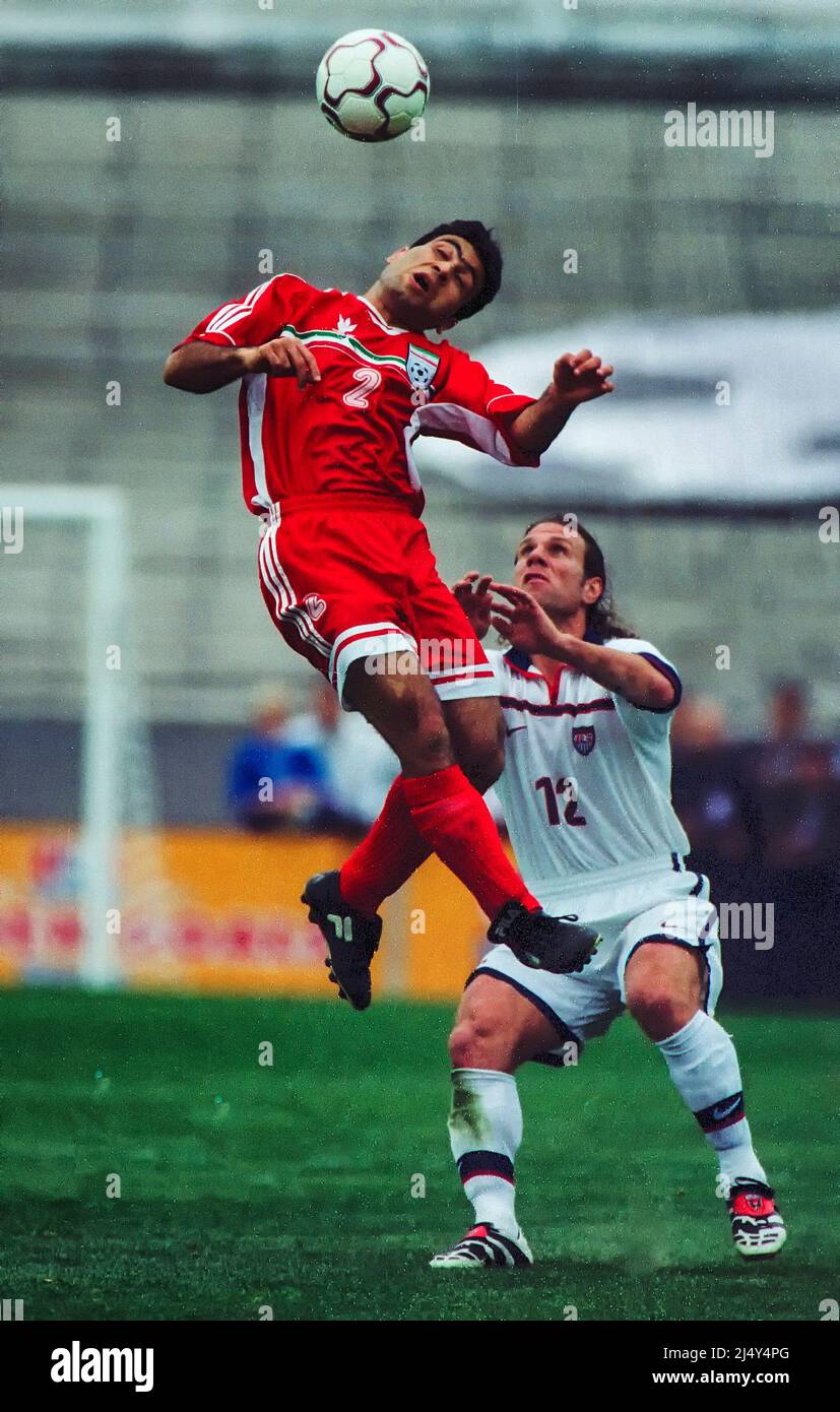Lyon, France: Mehdi Mahdavikia (2) of Iran heads away from Jeff Agoos (12) of the USA during a 1998 World Cup match between the United States and Iran Stock Photo