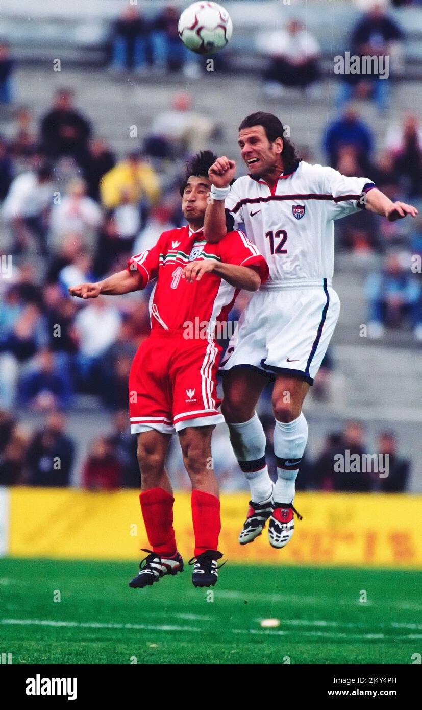 Lyon, France: Jeff Agoos (12) of the USA heads over Ali Reza Mansourian (7) of Iran during a 1998 World Cup match between the United States and Iran, Stock Photo