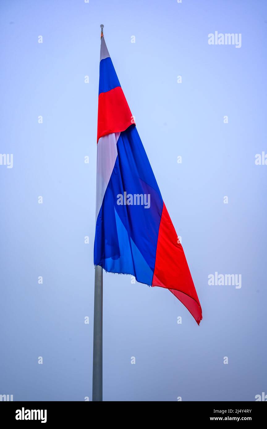Slovenian country flag against the blue sky. Isolated. Stock Photo