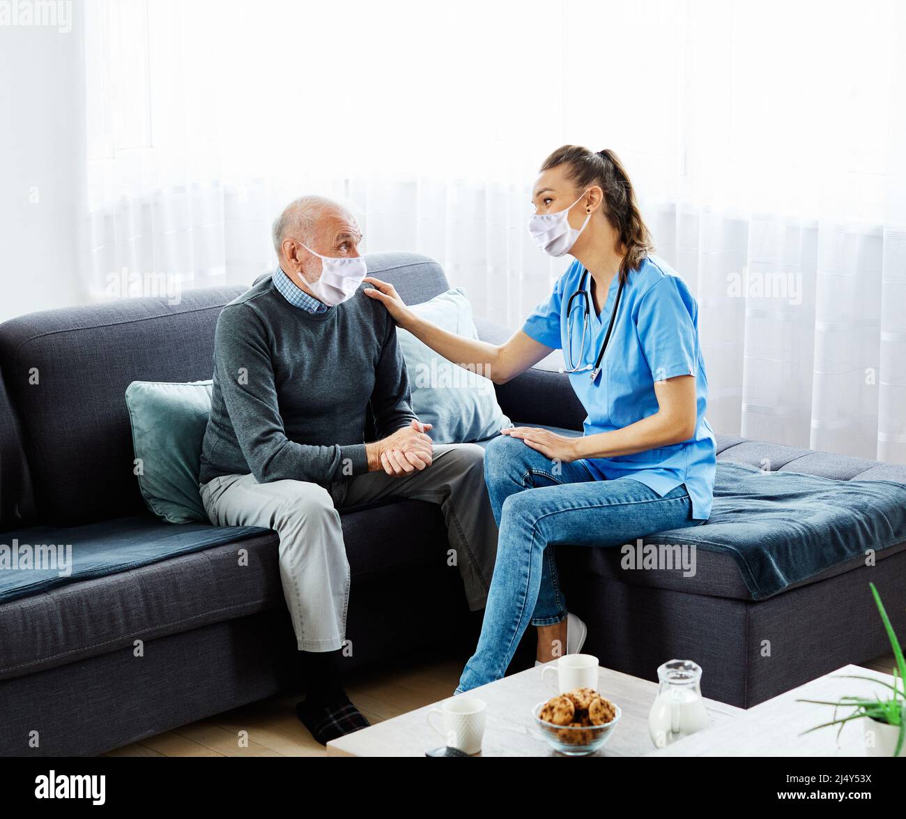 nurse doctor senior care caregiver help assistence retirement home nursing mask virus corona protection Stock Photo