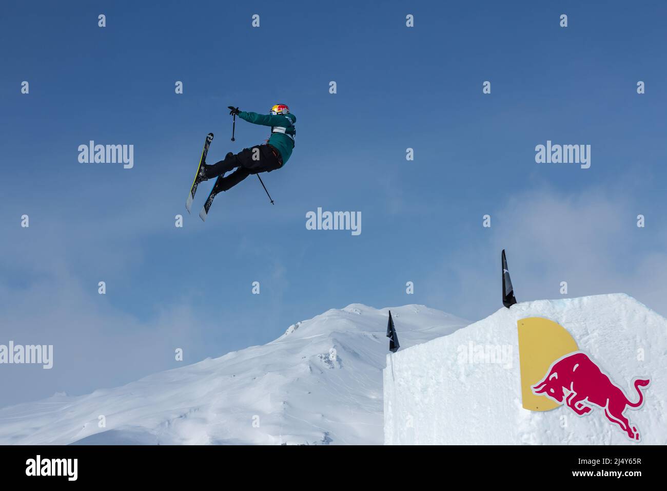 Athlete flies off ski jump with Red Bull advertisement Stock Photo