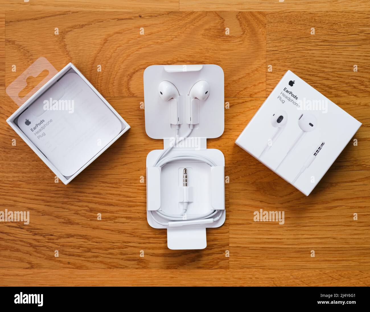 Tambov, Russian Federation - December 14, 2021 A New Apple EarPods unboxed on a wooden background Stock Photo
