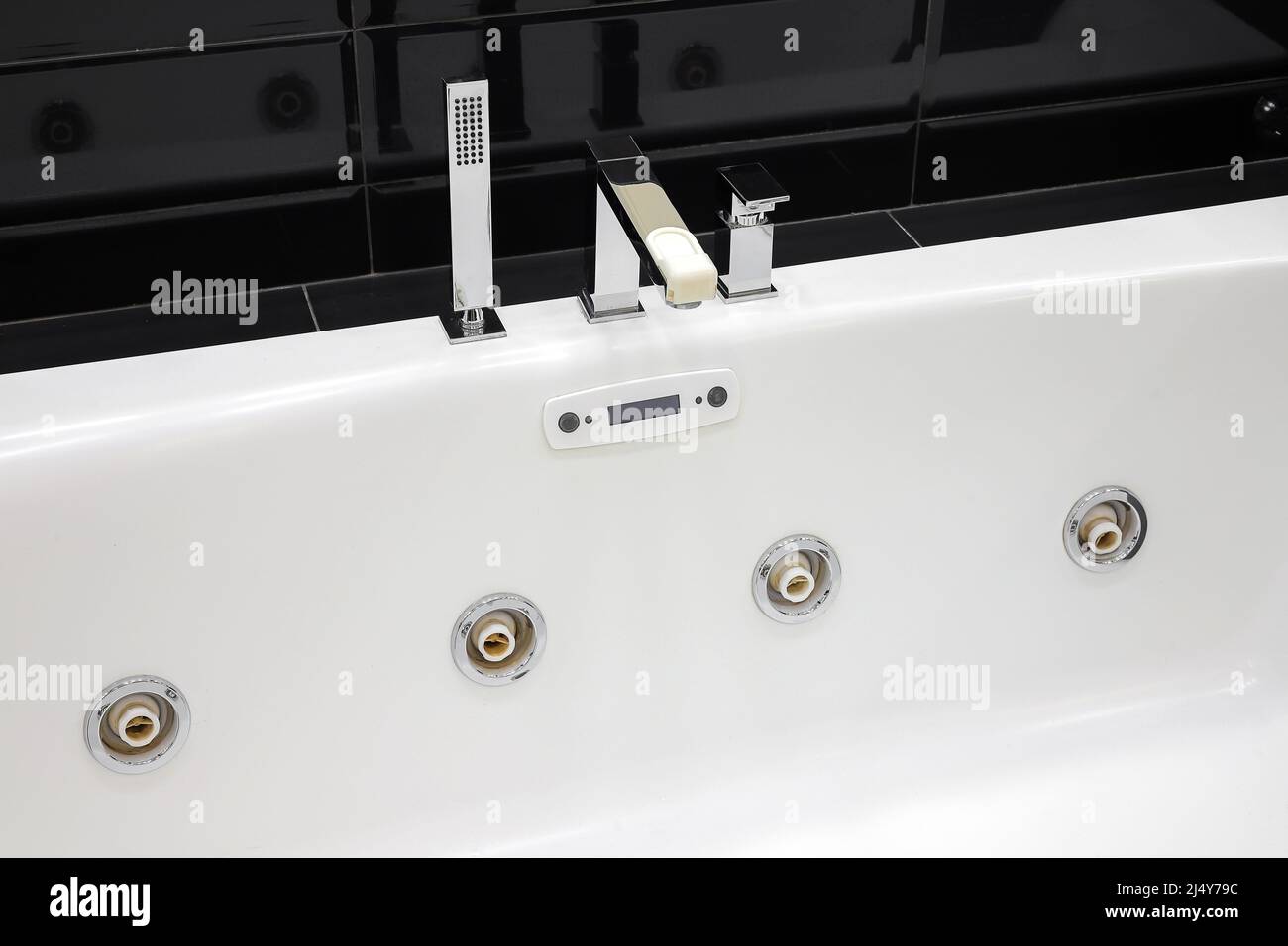 Faucet and white jacuzzi tub in modern bathroom Stock Photo