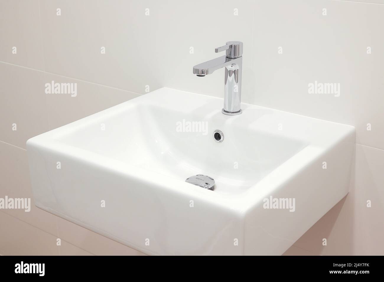 Modern white bathroom sink with faucet Stock Photo Alamy