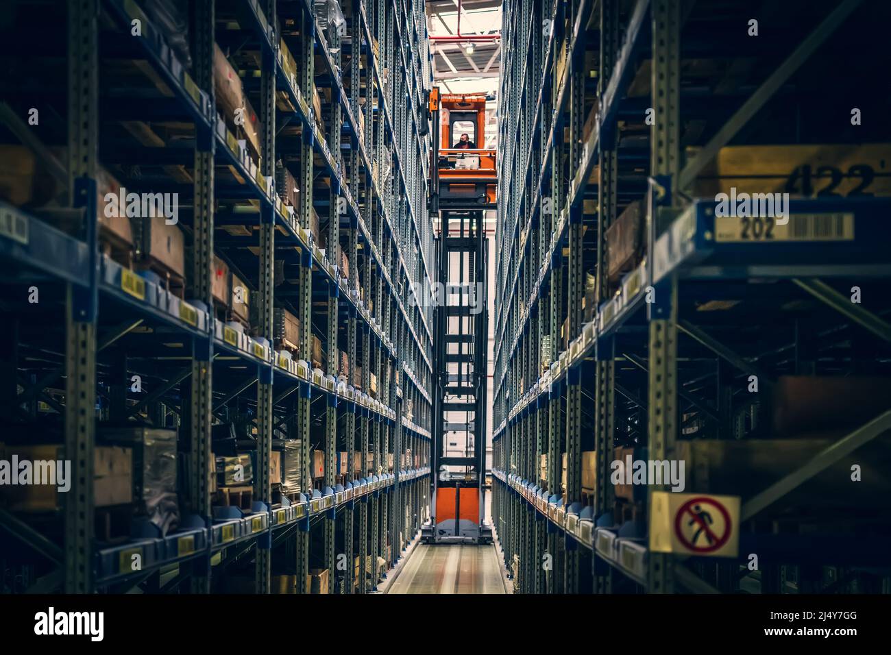 Modern distribution warehouse interior with many goods in boxes on shelves. Stock Photo