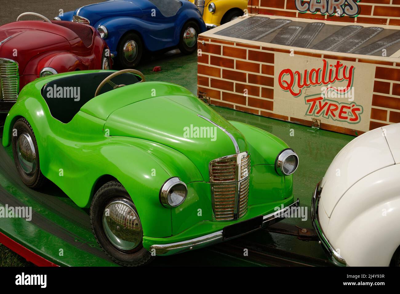 A fairground ride for children. Small 'cars' to steer and pretend to drive. Stock Photo