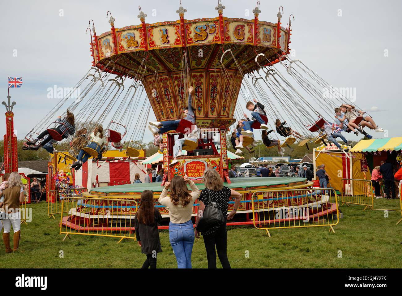 A Swinging Chair  'merry go round'  carousel at a fairground in England. Stock Photo