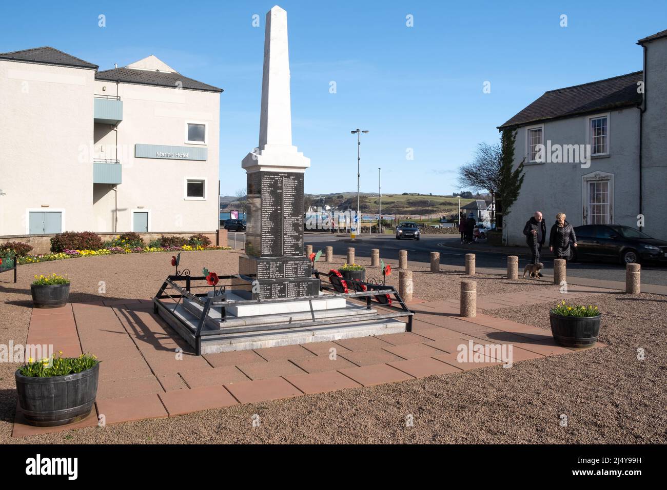 War Memorial in the North Antrim coastal town of Ballycastle, Northern Ireland with a view of the Marine Hotel. Stock Photo