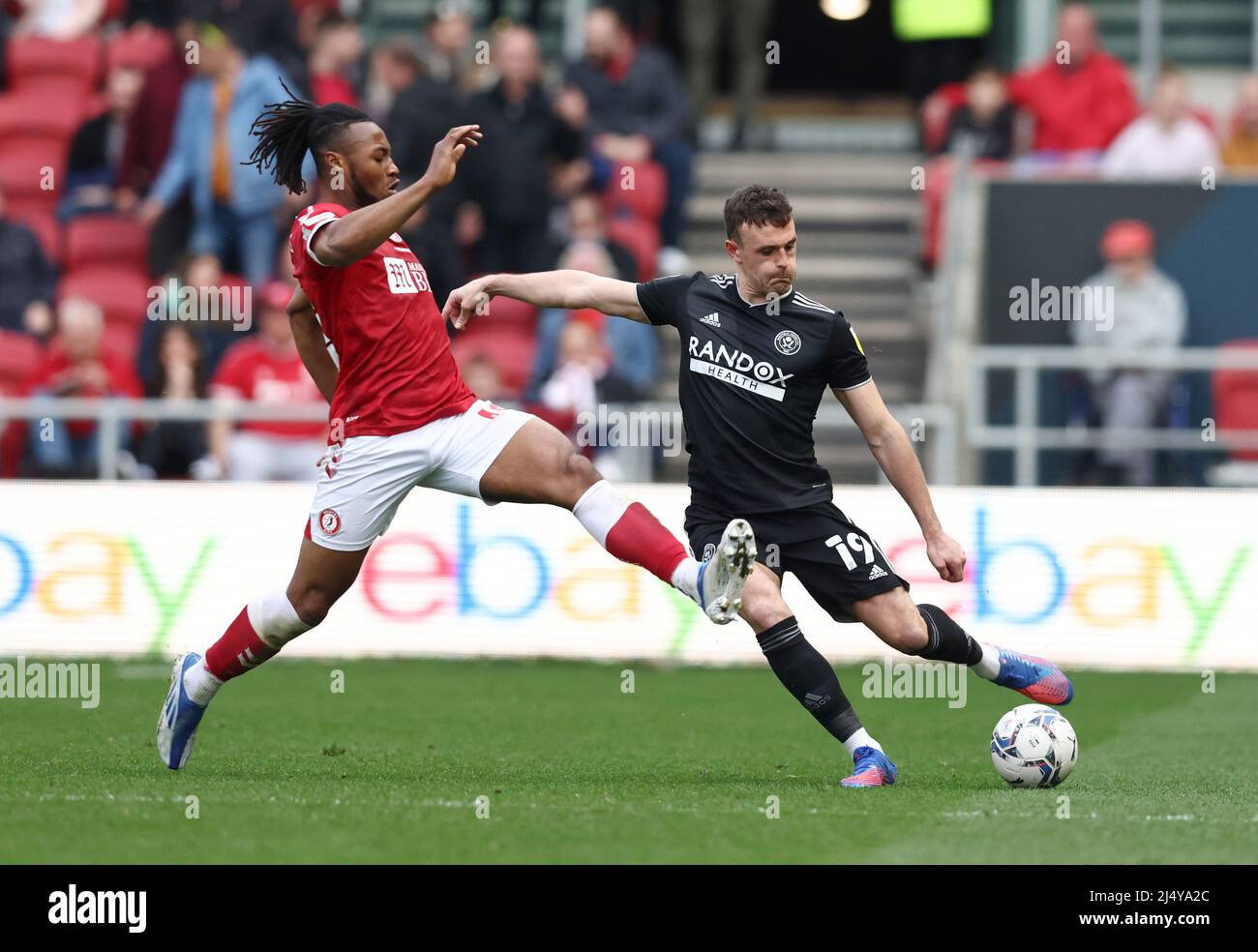 Bristol, England, 18th April 2022.   Antoine Sernenyo of Bristol City tackles Jack Robinson of Sheffield Utd during the Sky Bet Championship match at Ashton Gate, Bristol. Picture credit should read: Darren Staples / Sportimage Stock Photo
