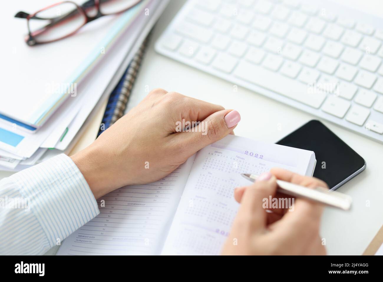 Filling business calendar for 2022 at workplace closeup Stock Photo Alamy