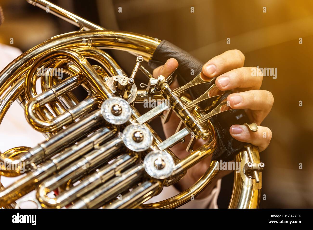 French horn instrument, hands playing horn player in philharmonic