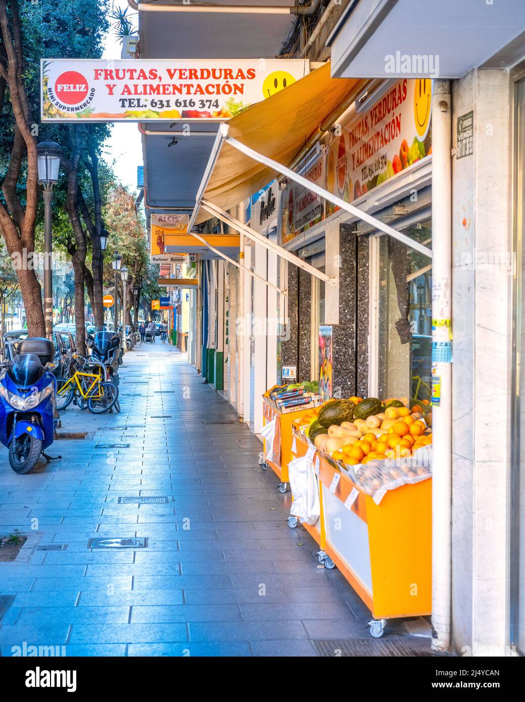 A fresh fruit and vegetables store is seen in a wide sidewalk in the old town area. There are no people in the scene. Valencia city is the capital of Stock Photo