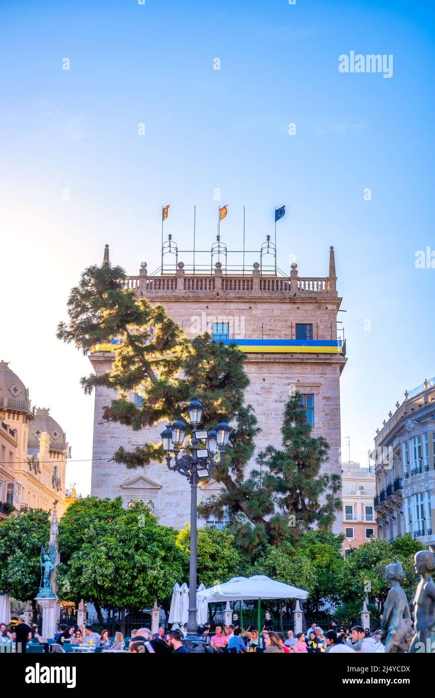 Group of tourists in the Virgin's Plaza where an old castle with the Ukrainian flag is seen. Tourism in the old town district. This area is a major to Stock Photo