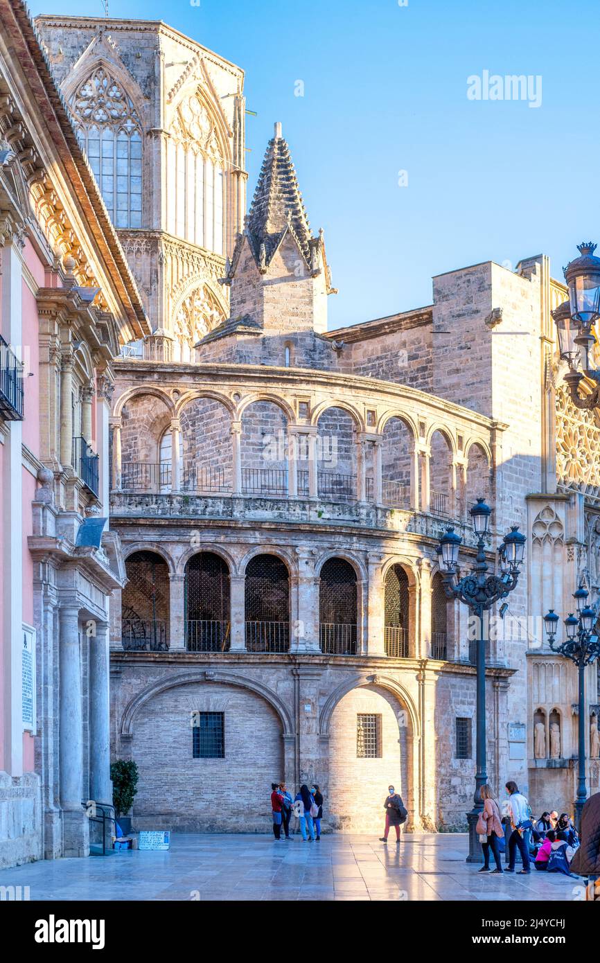 Exterior architecture of the Valencia Cathedral which has a predominantly Gothic style. Tourists are seen sightseeing in the old town.  This area is a Stock Photo