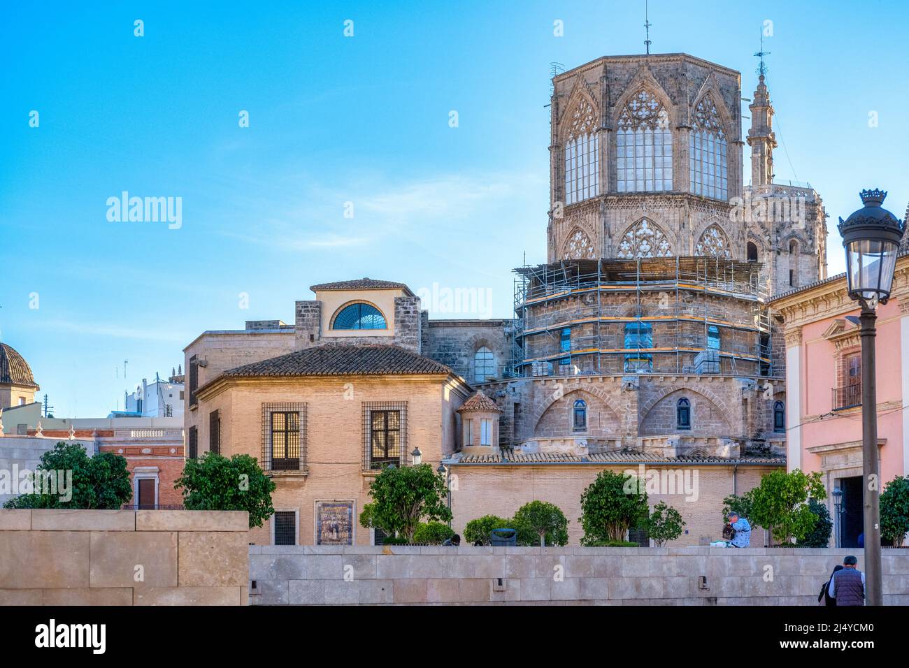 Exterior architecture of the Valencia Cathedral which has a predominantly Gothic style. Incidental people in the old town. This area is a major touris Stock Photo