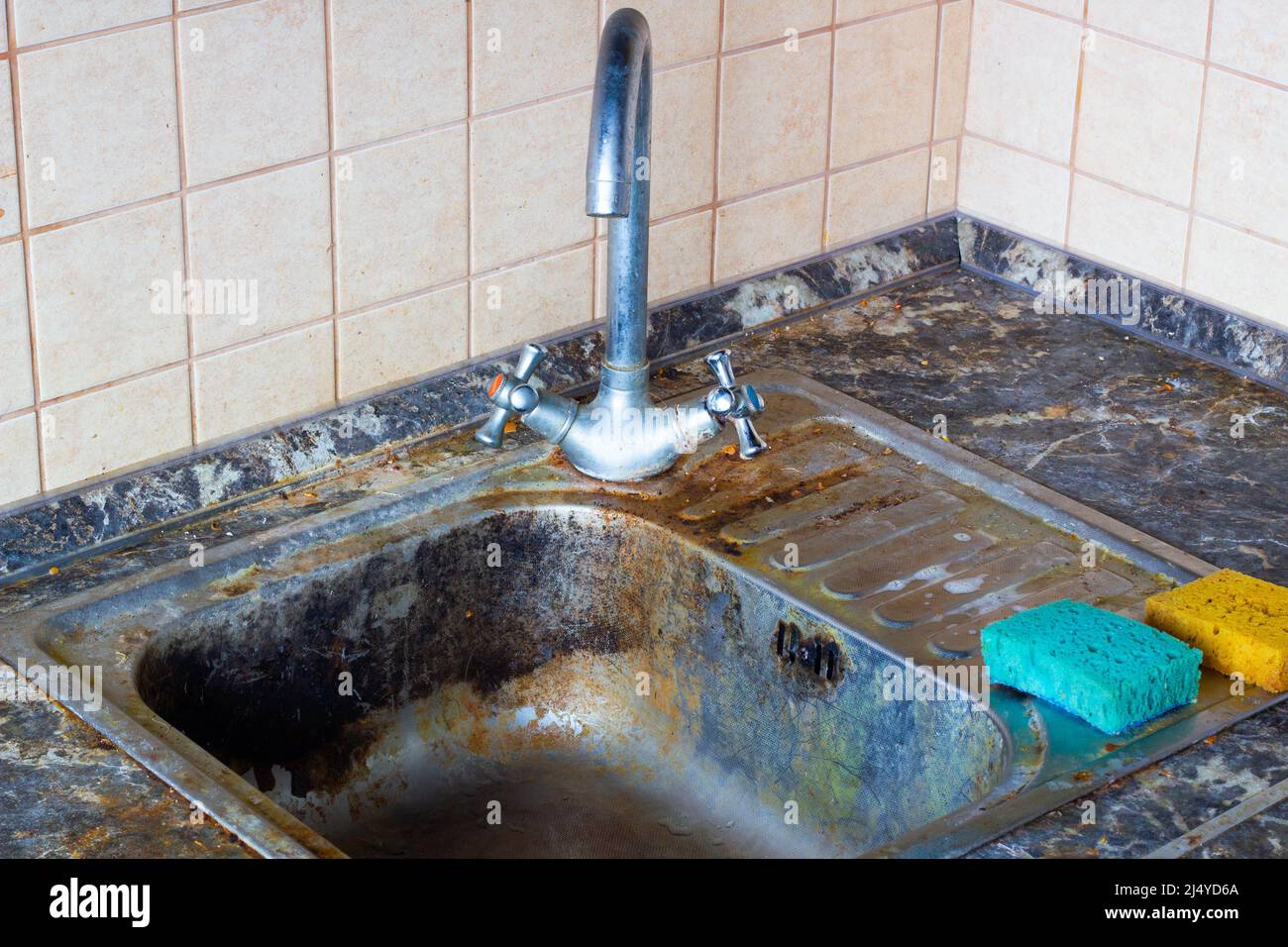 Very dirty kitchen sink. The kitchen and dishwashing area need to be