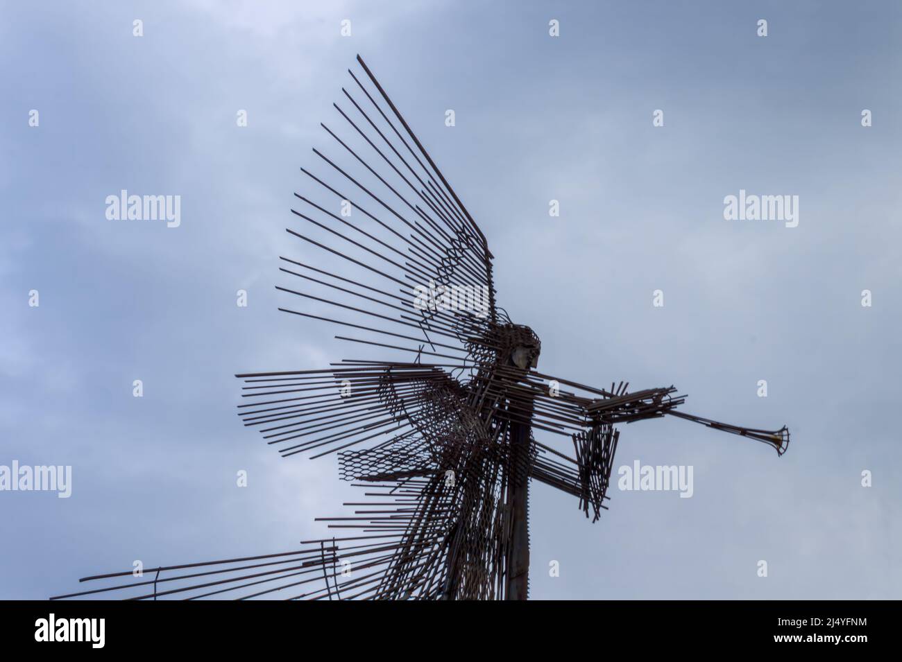 Chernobyl, Ukraine, May 11, 2019. Metal sculpture of a trumpeting angel against the blue sky in Chernobyl. Monument to the Chernobyl nuclear disaster. Stock Photo