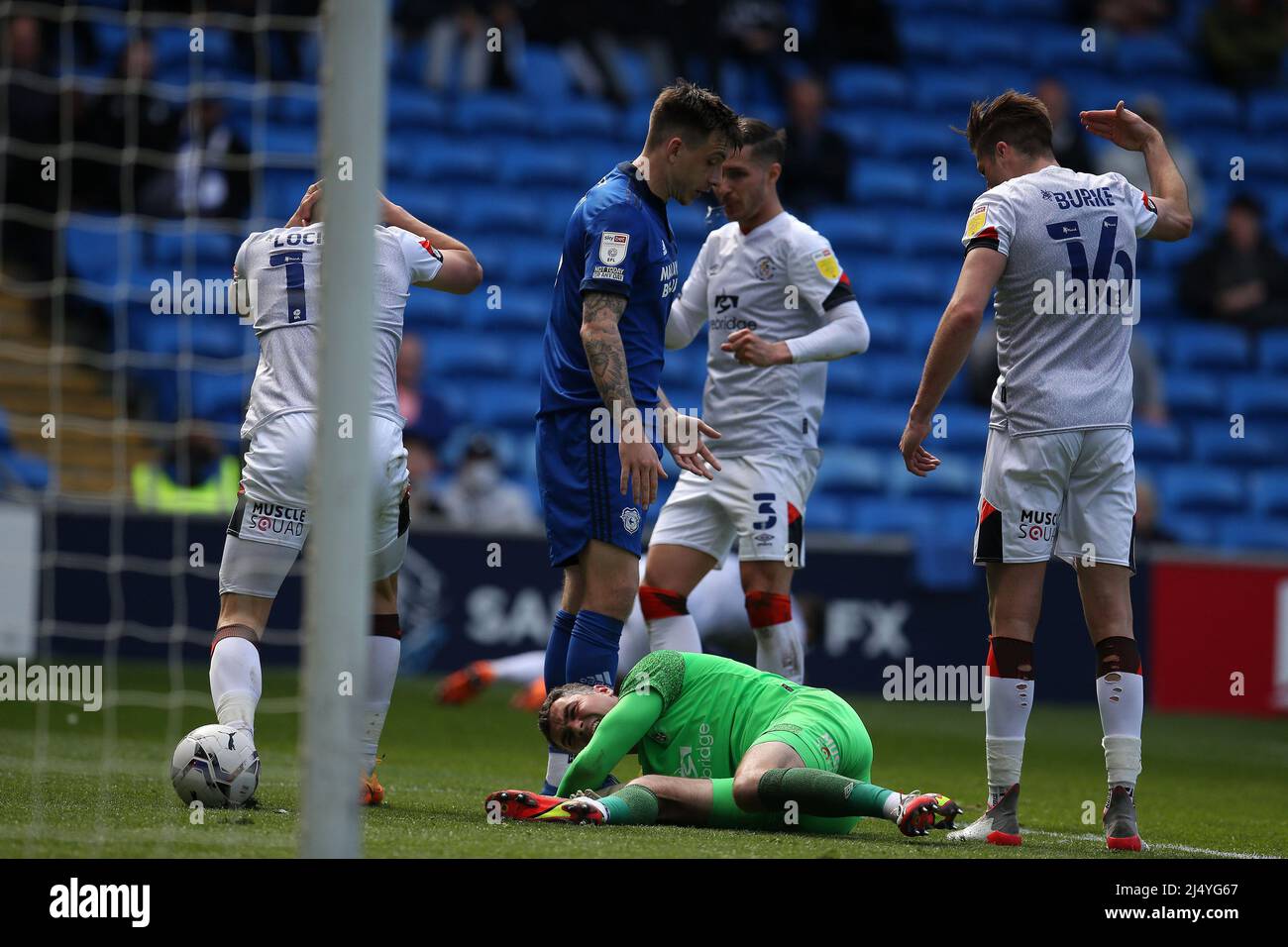 Cardiff, UK. 18th Apr, 2022. James Shea, the goalkeeper of Luton Town is injured during a collision with teammate Tom Lockyer of Luton Town (15). EFL Skybet championship match, Cardiff city v Luton Town at the Cardiff City Stadium in Cardiff, Wales on Easter Monday 18th April 2022. this image may only be used for Editorial purposes. Editorial use only, license required for commercial use. No use in betting, games or a single club/league/player publications. pic by Andrew Orchard/Andrew Orchard sports photography/Alamy Live news Credit: Andrew Orchard sports photography/Alamy Live News Stock Photo