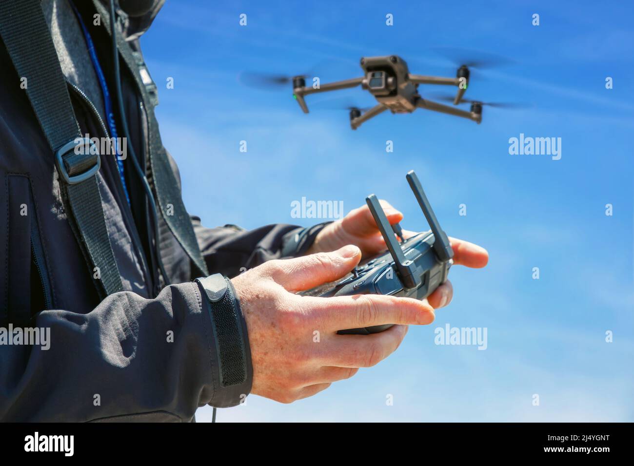 Pilot remotely controls the flight of a drone while making aerial ...