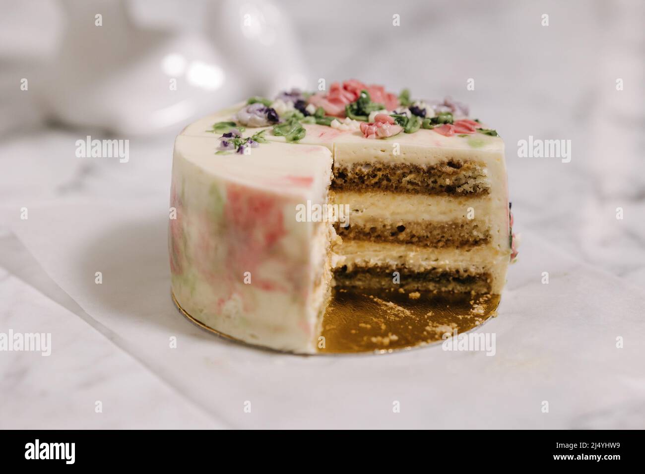 Slice of tiramisu bento cake. Presentation of cake in section. Sweet dessert for one person. Close-up of little birthday cake Stock Photo