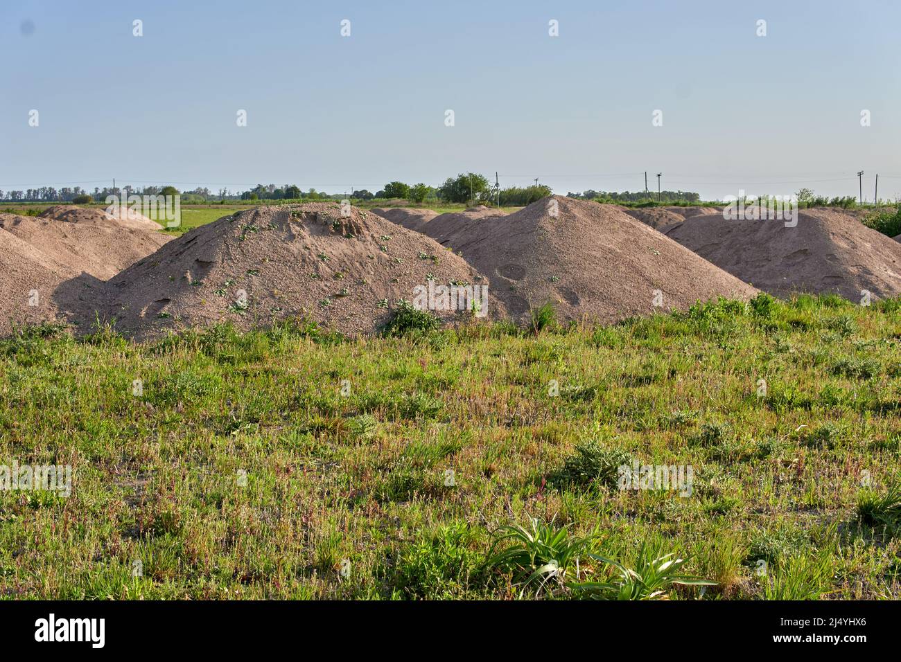 Land of Construction in rural Area in Argentina. Piles of dirt hauled on lots prepared for construction. Horizontal Stock Photo