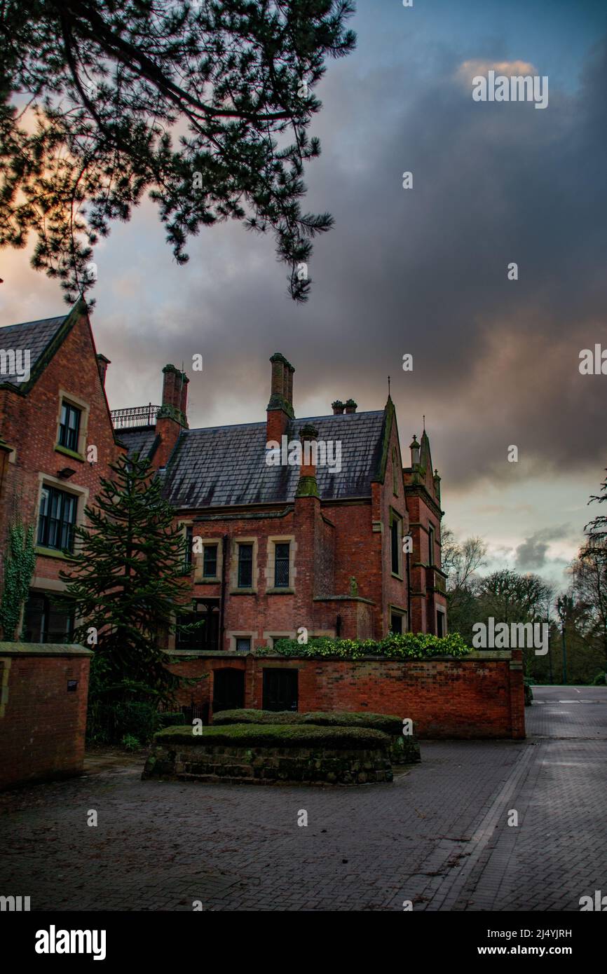 Grade II* Listed Abney Hall on a wet, stormy day in Cheadle, Greater Manchester, United Kingdom. Stock Photo