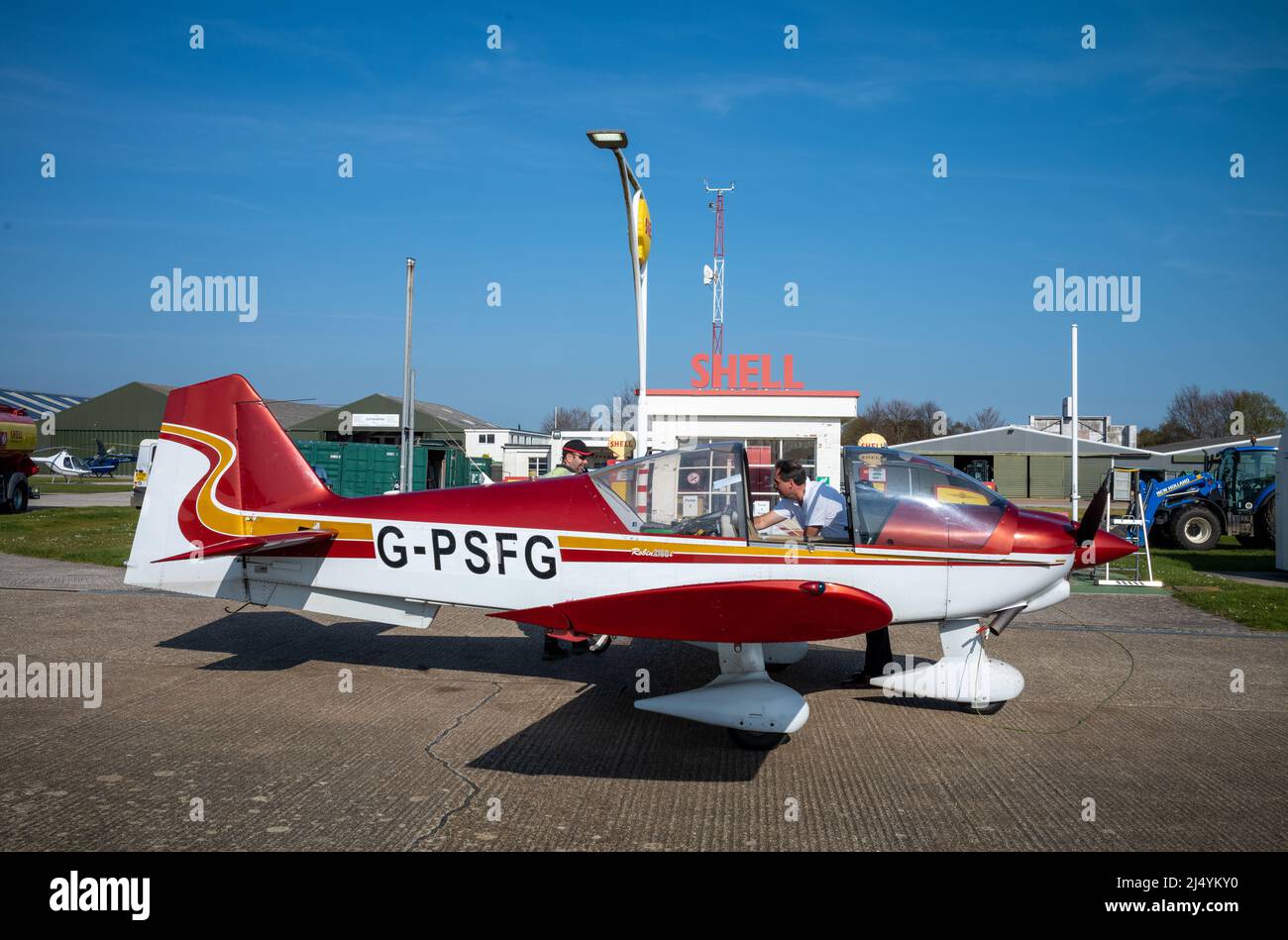 A pilot waits as his Robin 2160 2-seater plane is refuelled at Goodwood aerodrome in West Sussex, UK Stock Photo