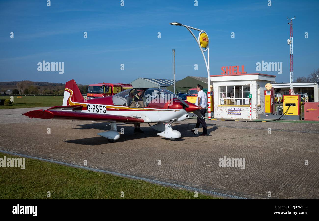 A pilot waits as his Robin 2160 2-seater plane is refuelled at Goodwood aerodrome in West Sussex, UK Stock Photo