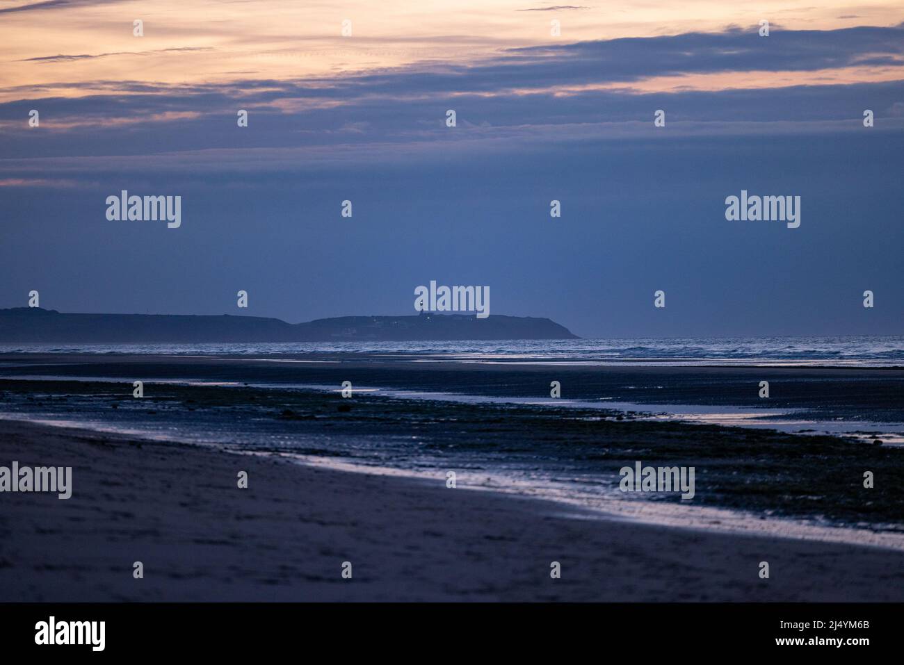 Beautiful ocean beach with a dramatic colourful sunset and beautiful waves at shore. High quality photo Stock Photo